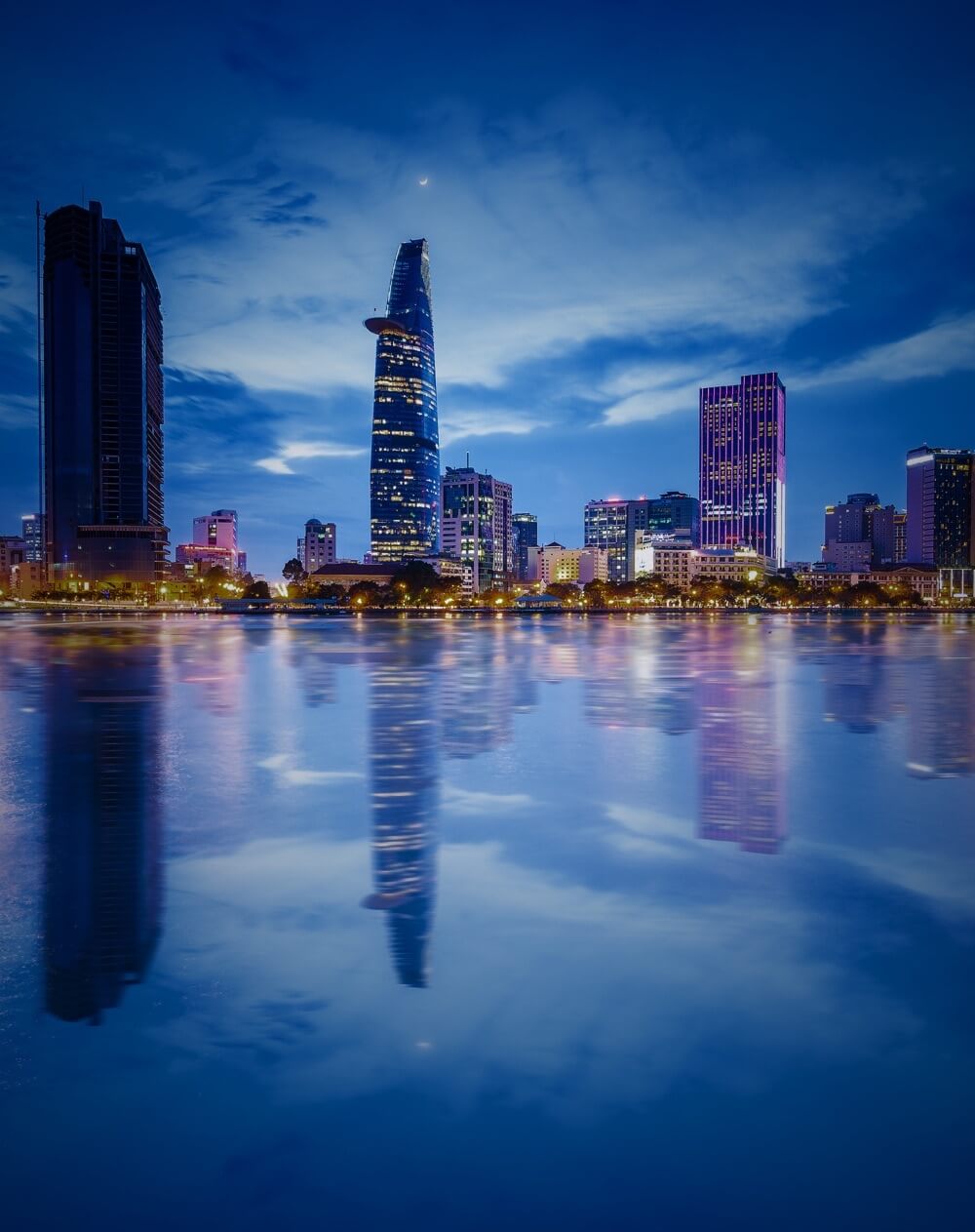 landscape night photo showing saigon business center and bitexco with their reflection on the river