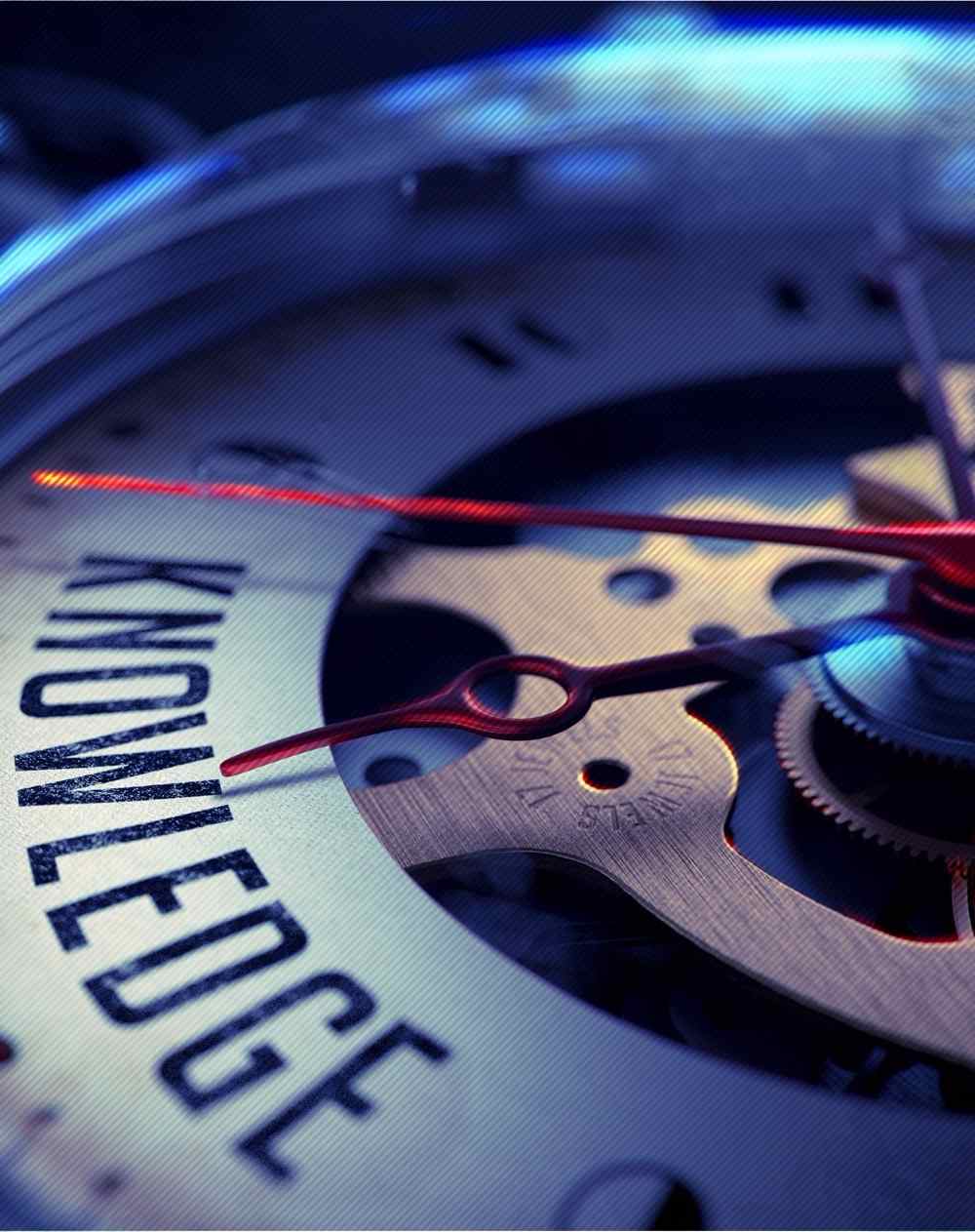 macro photo of a watch mechanism with one of the arrows pointing to the word knowledge